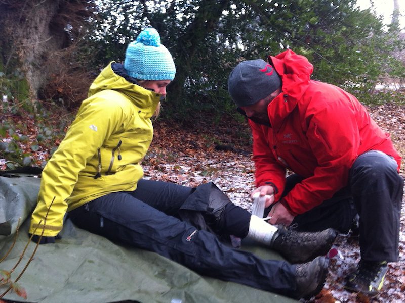 Bandaging a leg outdoors